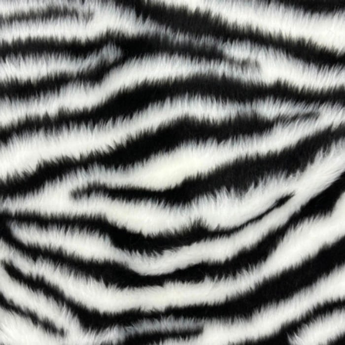 Muestra de tela peluche color cebra, textura de pelo.