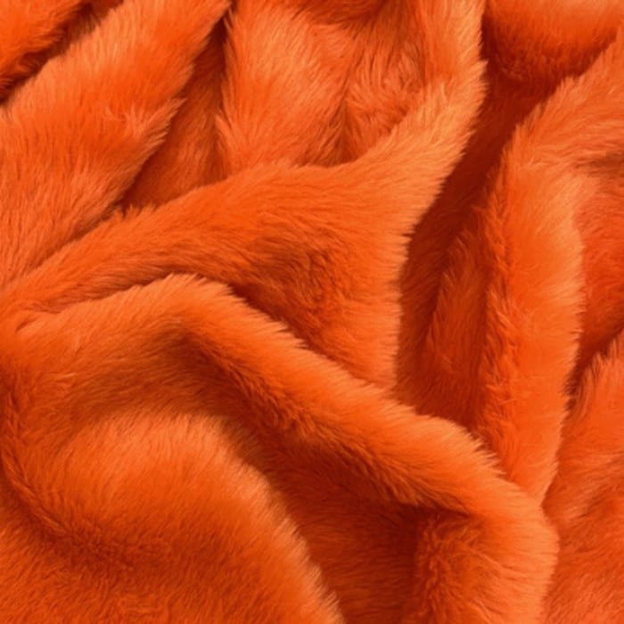 Muestra de tela peluche color naranja, textura de pelo.